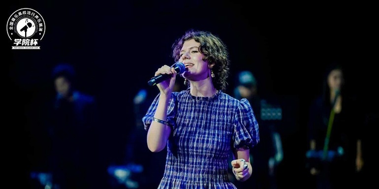 Alys Watson on stage in pop vocal competition in China