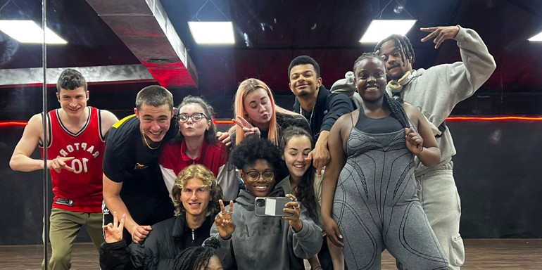 Cast of Channel 4 show Dreamers group selfie in a dance studio with a mirrored wall