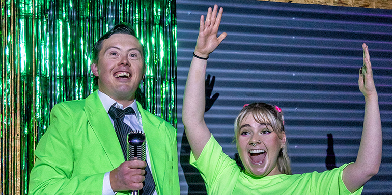 Dark Horse actor Joe Sproulle and Leeds Conservatoire graduate Kirsty Lucas performing in bright green attire