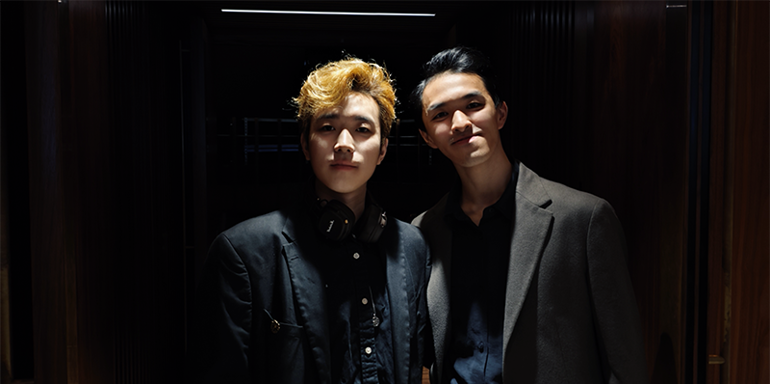 Zhouhan Du and choreographer George Liang stood together wearing dark clothing